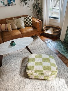 a living room filled with furniture and plants