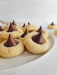 some cookies with chocolate on top are sitting on a plate