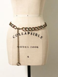 This is an adjustable chain belt with an antiqued gold tone finish. Each link is decorated with multi colored stones to include amber, green, red and light blue. The jeweled portion of the chain measures 30 inches. The adjustable portion measures 10 inches. Nice lobster claw clasp. Always happy to answer questions. All sales considered final unless item is grossly misrepresented. Thank you for shopping with us at We Wear Vintage! Bohemian Gold Chain Belt, Vintage Adjustable Chain Belt For Party, Adjustable Metal Chain Belt For Festivals, Bohemian Gold Chain Belt With Adjustable Chain, Vintage Metal Chain Belt With Adjustable Chain, Metal Chain Belt With Belt Loops For Festivals, Vintage Gold Chain Belt For Festivals, Adjustable Gold Bohemian Chain Belt, Adjustable Bohemian Gold Chain Belt