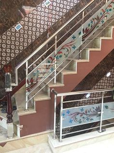 the stairs are decorated with decorative wallpaper and handrails, along with wrought iron railings