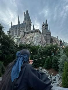 a woman is looking at the hogwarts castle