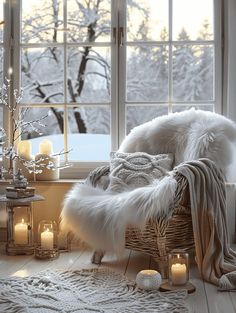 a white chair sitting in front of a window filled with candles and snow covered trees