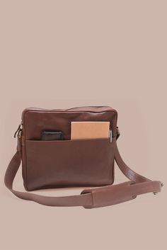 Carry your laptop in style & protection with our Leather Laptop Satchel in gorgeous brown leather. This sleek & durable satchel is specifically designed to fit a 13" laptop, ensuring your device stays safe while on the go. Lined in cotton with a YKK antique brass zipper closure Stay organized with two exterior pockets - one slip pocket with a magnetic closure on one side & a zippered pocket on the other to keep everything securely in easy reach Interior laptop divider & leather slip pocket Dimen Brown Crossbody Briefcase For Business, Brown Crossbody Laptop Bag For Business, Business Crossbody Laptop Bag In Soft Leather, Brown Leather Crossbody Laptop Bag, Casual Brown Rectangular Laptop Bag, Classic Brown Laptop Bag For Travel, Classic Brown Laptop Backpack, Cognac Laptop Bag With Leather Lining For Daily Use, Cognac Satchel Laptop Bag For Travel