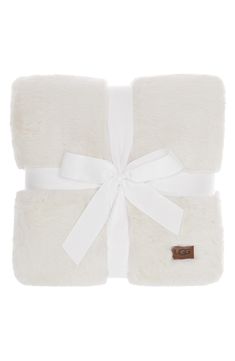 a white blanket with a bow on it