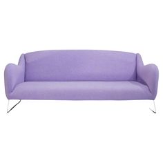 a purple couch sitting on top of a white floor next to a metal leg rest