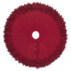 a round red rug with leaves on the bottom and a white circle in the middle