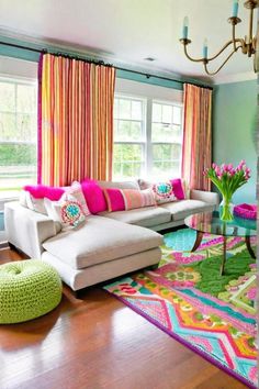 a living room filled with furniture and colorful curtains