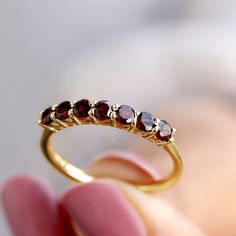 Product Details An amazing Garnet Gold Ring is crafted in Solid Gold with a lovely antique twist. Fascinating brilliant round Seven Garnet gemstone in a Basket Setting. This ring give you simply amazing look and Pair with other bands to make your own look. Make your bond more strong with your partner with this glamorous Gemstone Ring. Product Information SKU SHP-RINGS032012603 Width 3 mm Height 3 mm Weight 1.44 gm (Approximate) GARNET INFORMATION No.of Stones 7 Pieces Total Weight 1.05 Carat (Approximate) Dimension(approx) Round-3X3 mm-7 Pcs Color Red Cut Brilliant Shape Round Setting Type Shared-Prong-Setting Quality Grade AAA View More Product Parent Collection Handle garnet-rings Round Gemstone Rings, Garnet Gold Ring, Basket Setting, Garnet And Gold, Garnet Ring, 18k Yellow Gold Ring, Signature Jewelry, Timeless Jewelry, Garnet Rings