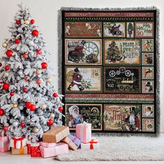 a white christmas tree sitting next to a wall hanging