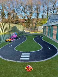 an outdoor play area with fake grass and toys