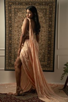 This baby peach pre-draped saree is a vision of elegance, crafted from Linen Satin fabric that glimmers with every movement. Paired with a Net blouse, the ensemble radiates sophistication and charm. The intricately hand-embroidered blouse adds a touch of glamour, making it perfect for a cocktail or reception, whether for the bride or her bridesmaids. With its timeless allure and delicate detailing, this saree is sure to captivate attention and leave a lasting impression on any special occasion.F Side Open Pre-draped Saree With Resham Embroidery For Parties, Party Side Open Pre-draped Saree With Resham Embroidery, Elegant Draped Pink Lehenga, Formal Pre-draped Saree With Pallu, Floor-length Peach Choli For Reception, Party Wear Pre-draped Saree For Wedding, Formal Draped Lehenga With Zari Work, Peach Traditional Drape Sets For Diwali, Elegant Peach Sharara With Traditional Drape