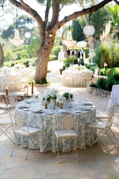 an outdoor table set up for a formal dinner