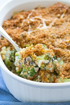 a casserole dish with broccoli, cheese and bread crumbs