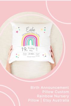 a pillow with the birth announcement for a child's rainbow nursery in australia on it