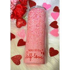 a pink flask with red hearts on it and the words ready on the left side