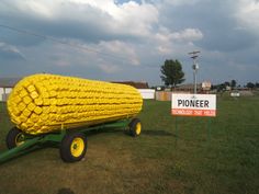 there is a wagon made out of tires on the grass with a sign in front of it