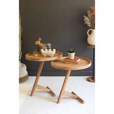 two small wooden tables with plants on them