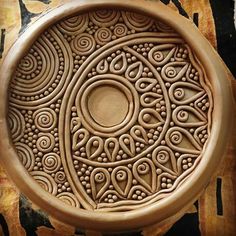 an intricately carved bowl sits on a table