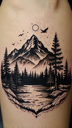 a man's thigh with a mountain scene and trees on the side, in black ink