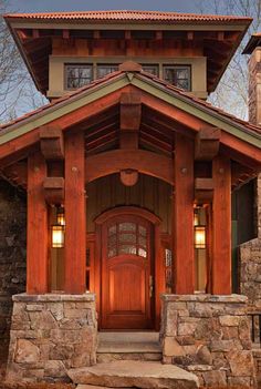 the front entrance to a home with stone steps leading up to it's door