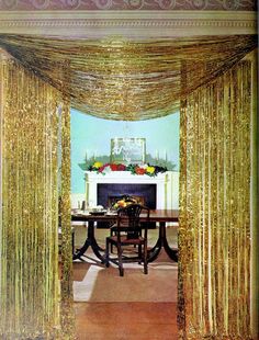 an image of a dining room with gold drapes on the ceiling and table in front of it