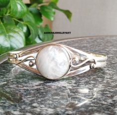 Large Rainbow Moonstone Bangle- Rainbow Silver Jewelry- Rainbow Moonstone Jewelry-925 Sterling Silver Bangle- Amezing Designer Bangle's Description Metal :- 925 Sterling Silver Style : Bangle Gemstone:- Moonstone Benefits Of Moonstone  Moonstone is good for activating your creative and intuitive power of feminine energy which helps you get in tune with your true emotions. It can help balance and cool down your emotions and tension. The tranquil energy of the moonstone invites creativity, restoration, and motherly protection Occasion : Birthday Events, Lovely Valentine's Day Gift, Anniversary Gift, Weeding Gift, Engagement Bangle, Lover Gift Bangle, Hen Party And Other Occasion.... Your order will be handmade and ready for shipment in 1 to 1 business days Normally we ship via U... Adjustable Moonstone Bangle Bracelet, White Moonstone Bangle, Silver Moonstone Bangle, Moonstone Benefits, Nickel-free Sterling Silver Spiritual Bangle, Spiritual Silver-colored Brass Bangle, Rainbow Moonstone Jewelry, Bracelets Design, Sterling Silver Bangle