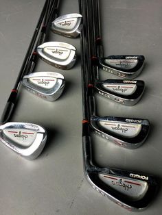 several different types of golf irons lined up on a table with the names of their clubs