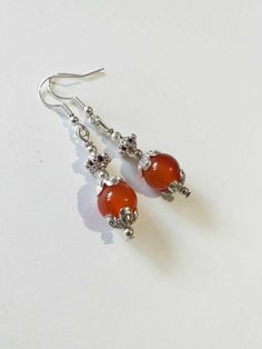 Carnelian Victorian Silver earrings Boho Earrings Silver Carnelian earrings orange-red jewelry Carnelian earring Carnelian jewelry gift set Carnelian Victorian earrings Bohemian earrings . Beautiful Set of silver-tone ornament beads and Genuine Carnelian necklace and earrings. Silver-tone Victorian style necklace and earrings. Boho necklace. Bohemian necklace and earrings. Romantic necklace and earrings. Beautiful necklace with same style earrings with Genuine Carnelian.  Perfect Gift for girlfriend,  mother,  sister,  bridesmaids or Maid of honor. Gift for special people or jewelry set for your special occasion. You may choose from the options menu from: earrings,  jewelry set earrings and necklace,  and jewelry set earrings and necklace + same style bracelet. FREE SHIPPING   Material: si Round Carnelian Earrings, Carnelian Drop Earrings With Natural Stones, Carnelian Natural Stone Drop Earrings, Amber Carnelian Gemstone Earrings, Red Carnelian Gemstone Earrings, Carnelian Dangle Jewelry With Matching Earrings, Carnelian Dangle Earrings With Natural Stones, Nickel-free Red Carnelian Earrings, Round Carnelian Gemstone Earrings