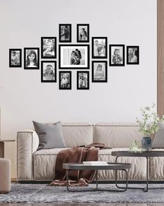 a living room filled with furniture and framed pictures on the wall above a coffee table