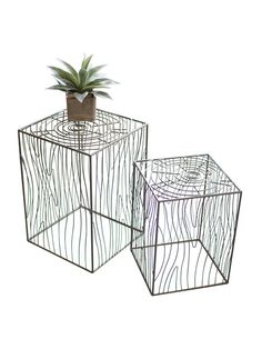 two metal planters sitting next to each other