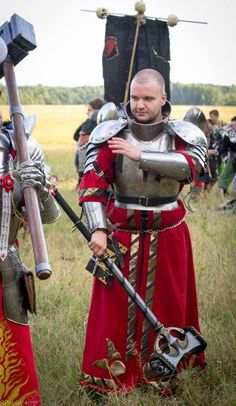 two men dressed in medieval armor standing next to each other