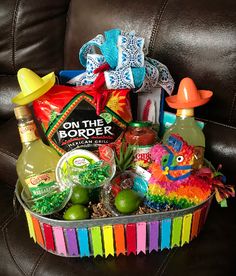 a gift basket filled with alcohol, condiments and candies for someone's birthday