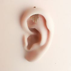 a pair of ear piercings sitting on top of a white surface