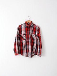 A classic vintage JC Penney Big Mac plaid work shirt. The flannel cotton shirt features a bold red, black, and white print. Bias cut patch pockets detail the chest. It buttons closed. • JC Penney Big Mac shirt• 100% Cotton• plaid flannel• pockets on chest• button down• button cuffsCONDITIONIn good condition with wear consistent with age and use. MARKED SIZE:  MMEASUREMENTSBust:          22.5" (45)     ...       57.2 cm (114.3)Length:      27.5"            ...        69.9 cmSleeves:    32.5" Vintage Red Button-up Flannel Shirt, Vintage Plaid Cotton Flannel Shirt, Retro Plaid Button-up Flannel Shirt, Vintage Red Flannel Shirt, Retro Red Collared Flannel Shirt, Retro Collared Cotton Flannel Shirt, Retro Cotton Collared Flannel Shirt, Retro Plaid Flannel Top, Vintage Plaid Button-up Flannel Shirt