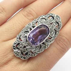 Great vintage condition.  925 Sterling Silver Vintage Amethyst & Marcasite Gem Statement Ring Size 7.25  Weight: 20.4g   WELCOME TO PAWN SHOP We are an actual pawn shop and have been in business for over 25 years. Since 1990, our establishment has been serving a variety of clients by providing them with short term cash solutions and options of liquidity regarding their treasured heirlooms. Acknowledging that today′s customers are very sophisticated and are looking for a variety of investments, o Vintage Silver Gemstones For Anniversary, Vintage Sterling Silver Amethyst Ring With Stone Setting, Vintage Silver Rings With Gemstone Accents, Vintage Multi-stone Silver Gemstones, Vintage Silver Amethyst Ring With Accent Stones, Vintage Silver Multi-stone Gemstones, Vintage Silver Amethyst Ring With Stone Setting, Antique Silver Amethyst Sterling Silver Ring, Antique Silver Amethyst Ring