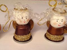 three little angel ornaments sitting on top of a table