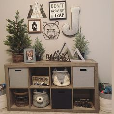 a shelf with some baskets and pictures on it