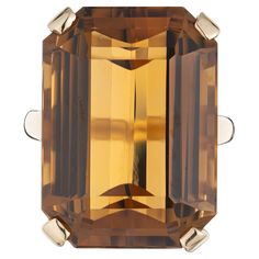 Vintage 1960's burnt orange ( Madera ) color emerald cut citrine ring cocktail ring. Stunning 36.60 Carat Madera Emerald Cut Citrine set in a 14k yellow gold setting. The citrine color is vibrant and rich with yellow and orange hues. The Madera citrine is known for its exceptional clarity and brilliance, the emerald cut not only enhances the stone's natural beauty, but also creates a unique and modern look. 1 rectangular emerald cut yellowish orange citrine, approx. 36.60cts Size 6.5 and sizable Formal Rings With Faceted Rectangular Stone, Formal Emerald-cut Faceted Topaz Ring, Formal Emerald Cut Faceted Topaz Ring, Formal Emerald Cut Polished Topaz Ring, Formal Emerald Cut Topaz Ring With Polished Finish, Art Deco Citrine Topaz Ring For Formal Occasions, Formal Topaz Ring With Rectangular Stone, Formal Rectangular Topaz Stone Ring, Orange Citrine