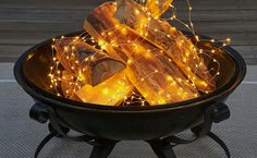 some logs are in a black bowl with lights on them and there is no image here to provide a caption for