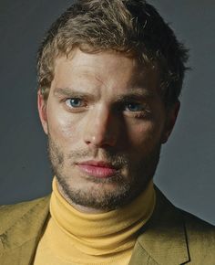 a man in a yellow turtle neck sweater