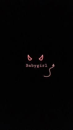 the word babygirl is lit up in the dark with red lights on it's face