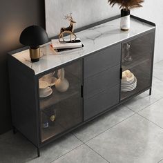 a black and white sideboard with glass doors on the bottom, two vases sitting on top of it