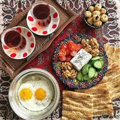 an assortment of food including crackers, tomatoes, cucumbers and eggs