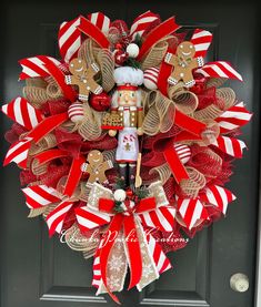 a christmas wreath with a nutcracker and reindeers on it, hanging from the front door