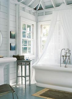 a white bath tub sitting next to a window