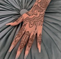 a henna tattoo on the palm of someone's hand