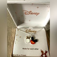 the disney mouse necklace is in its box