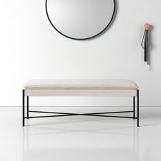 a bench with a mirror on the wall behind it