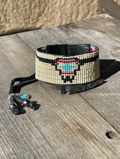 All your favorite Southwestern rich colors packed into one cuff. Stack it with some of your favorite pieces or wear alone as a show piece. Made with: * Toho - glass seed beads * Black Leather * Silver button (plated) * Sterling silver/Turquoise charm * Buffalo nickel charm * 2 Navajo pearls * Sterling silver charm holder * Black deer skin lace Note: Our new leather cuffs have been made so that one size fits all. It works like a bit like the draw string/leather method. The excess deer skin lace w Adjustable Western Cuff Bracelet For Festivals, Adjustable Western Style Cuff Bracelet For Festivals, Adjustable Western Style Festival Cuff Bracelet, Western Style Adjustable Cuff Bracelet For Festivals, Adjustable Cuff Beaded Bracelets For Festival, Adjustable Southwestern Cuff Bracelet, Southwestern Adjustable Cuff Bracelet, Adjustable Southwestern Style Cuff Bracelet For Festivals, Adjustable Southwestern Cuff Bracelet For Festivals