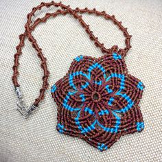 This beautiful Mandala necklace made in classic macrame technique in brown (Earth) and blue (Sky) colours.  This necklace will help you to  to find the unity with the nature  - Mother-Earth and Father-Sky. The necklace measures approx 16 inch / 41 cm.  Pendant (the Mandala) -3 x 3 inch / 7.5 x 7.5 cm   The necklace will come gift wrapped in nice organza gift pouch. This eye-catching necklace can be a perfect gift! Call again and thanks for looking! Sat Nam Artisan Brown Handwoven Necklace, Brown Macrame Necklaces For Festivals, Brown Macrame Necklace For Festival, Artisan Brown Necklace With Adjustable Cord, Brown Handwoven Necklace For Gifts, Earthy Handmade Blue Necklace, Earthy Brown Macrame Jewelry, Brown Macrame Nature-inspired Jewelry, Nature-inspired Brown Macrame Jewelry